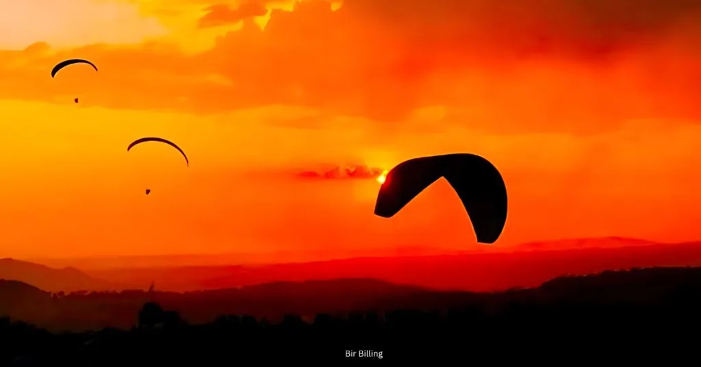 A breathtaking view of paragliding at sunset